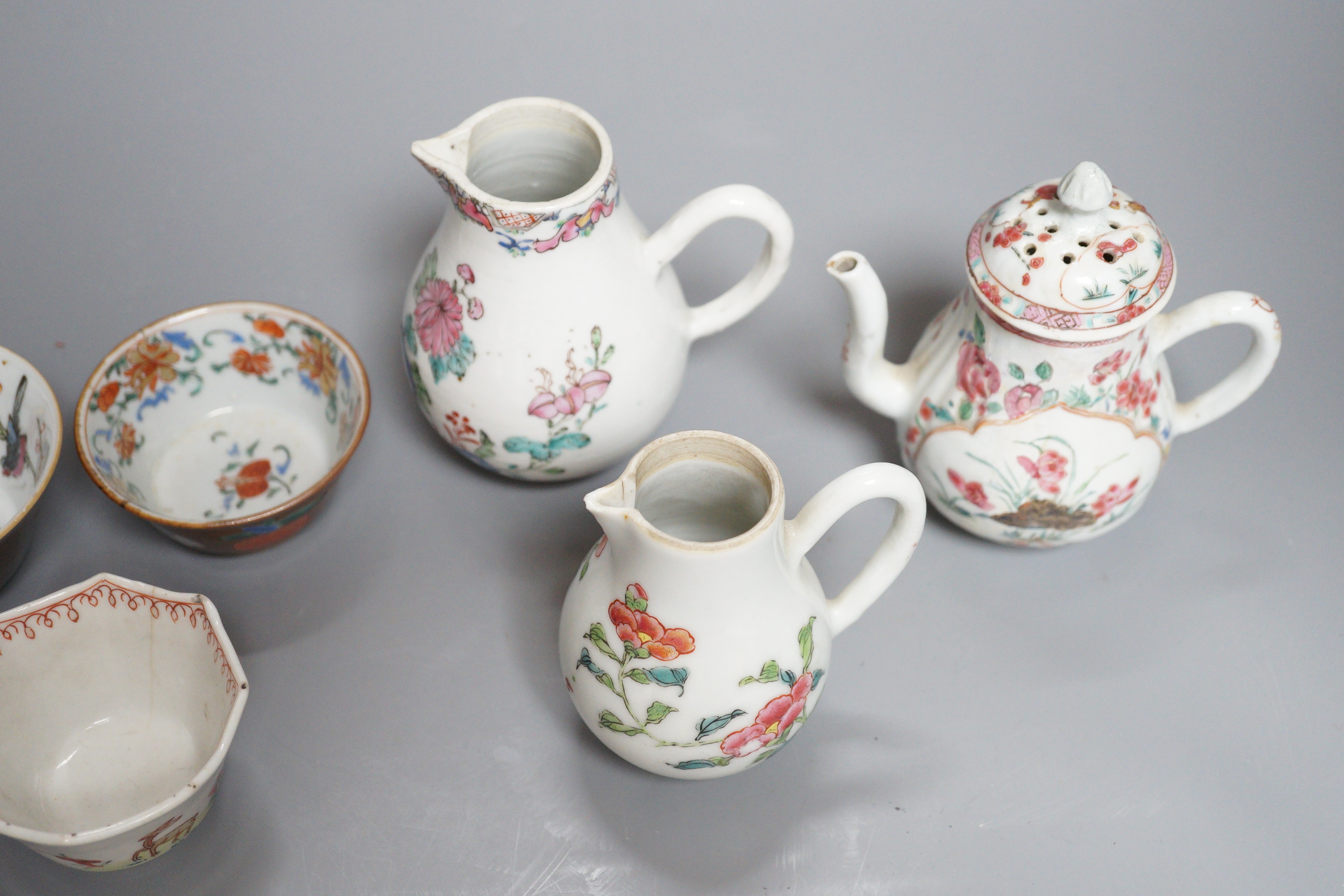 Three Chinese export famille rose cream jugs, one with pierced cover and three small bowls, 18th century and later